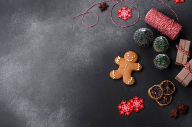 Christmas decorations and gingerbreads on a dark concrete table. Preparing and decorating the house for holiday