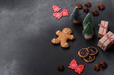 Christmas decorations and gingerbreads on a dark concrete table. Preparing and decorating the house for holiday