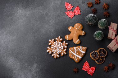 Christmas decorations and gingerbreads on a dark concrete table. Preparing and decorating the house for holiday