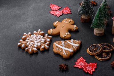 Christmas decorations and gingerbreads on a dark concrete table. Preparing and decorating the house for holiday