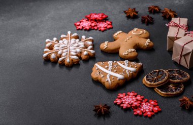 Christmas decorations and gingerbreads on a dark concrete table. Preparing and decorating the house for holiday