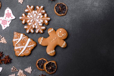 Christmas decorations and gingerbreads on a dark concrete table. Preparing and decorating the house for holiday