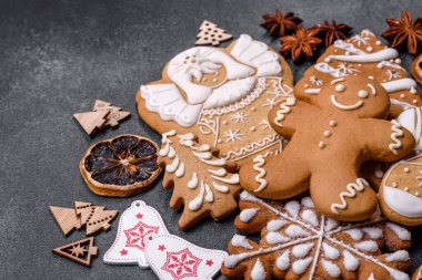 Christmas decorations and gingerbreads on a dark concrete table. Preparing and decorating the house for holiday