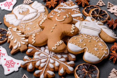Christmas decorations and gingerbreads on a dark concrete table. Preparing and decorating the house for holiday