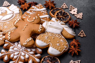 Christmas decorations and gingerbreads on a dark concrete table. Preparing and decorating the house for holiday