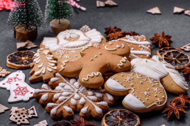 Christmas decorations and gingerbreads on a dark concrete table. Preparing and decorating the house for holiday