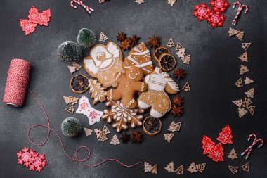 Christmas decorations and gingerbreads on a dark concrete table. Preparing and decorating the house for holiday