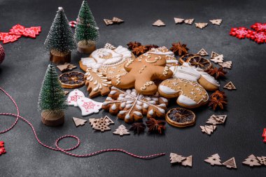 Christmas decorations and gingerbreads on a dark concrete table. Preparing and decorating the house for holiday