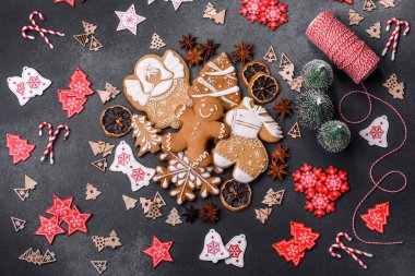 Christmas decorations and gingerbreads on a dark concrete table. Preparing and decorating the house for holiday