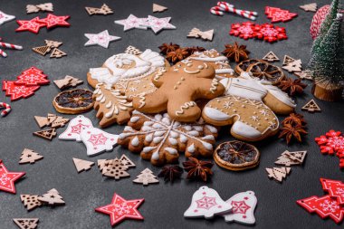 Christmas decorations and gingerbreads on a dark concrete table. Preparing and decorating the house for holiday