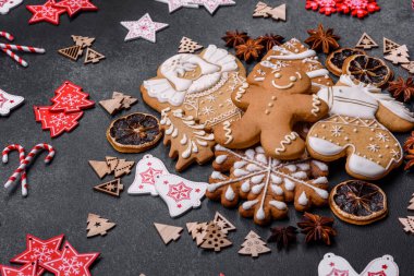 Christmas decorations and gingerbreads on a dark concrete table. Preparing and decorating the house for holiday