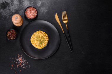 Mısır taneli yengeç salatası, porsiyon olarak siyah bir tabağa serilmiş, bayram sofrasında servis ediliyor.