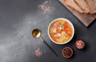 Şehriyeli tavuk çorbası ve sebzeler kırsal beton arka planda. Ev yapımı sağlıklı yemek.