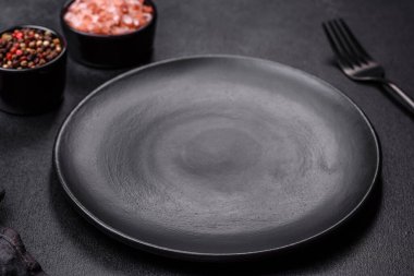 Beton bir masada siyah çatal bıçak takımı. Yemek masası hazırlığı