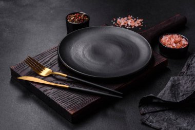 Beton bir masada siyah çatal bıçak takımı. Yemek masası hazırlığı