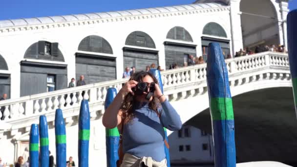 意大利 威尼斯 年轻姑娘在格兰德河大桥 Canal Grande Rialto Bridge 的加泰罗尼亚拍照 随着意大利科维德19号船 Covid — 图库视频影像
