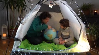 Avrupa, İtalya, Milano - Covid-19 Coronavirus tecridi sırasında evde baba ve oğul bir kamp evinde otururken - seyahat arzusu