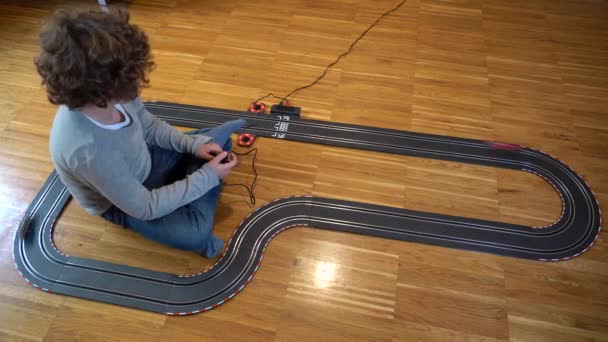 Child Year Old Boy Plays Home Alone Electric Car Track — Vídeo de Stock