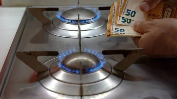 increase in the cost of raw materials due war conflict Ukraine Russia, energy and gas and in household bills - money euro cash banknotes and gas cookers