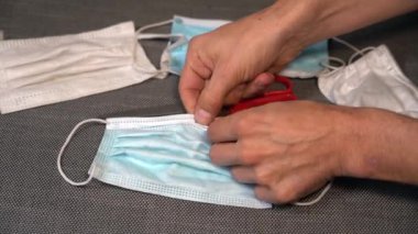 The disposal of medical masks on white background, some European countries have lifted COVID-19 measures completely and medical masks are not needed