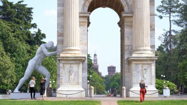 Europe, Italy, Milan May 2022 - Mr Arbitrium is a 5.4 meter tall sculpture by the artist Emanuele Giannelli posed near Arch of peace ( Arco della Pace ) touristic attraction sightseeing in downtown