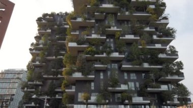 Europe, Italy, Milan July 2022 - footage of vertical forest luxury building Modern and ecologic skyscrapers with many trees on every balcony. Bosco Verticale