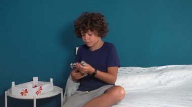 footage of an 8-year-old boy alone at home finding a real gun in his parents' drawer - in America more and more children find guns in domestic places - social danger and violence