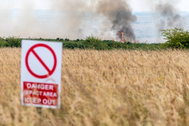 Salisbury Plain, Wiltshire, England, 7th July 2022Flames and smoke visible only a few hundred meters from a public byway closed for safety shortly after this photo was taken