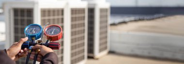 technician checks the operation of the air conditioner.