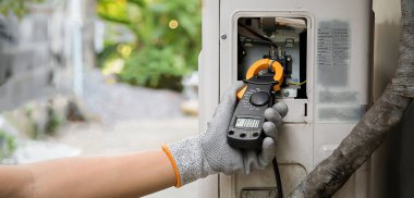 Technician checking the operation of the air conditioner.