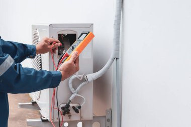 Technician checking the operation of the air conditioner