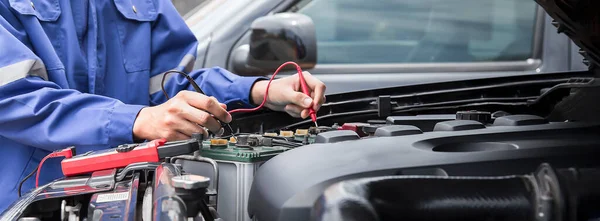 Technicians inspect the car\'s electrical system.