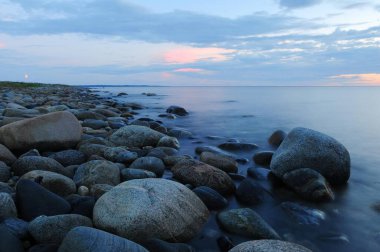 The dragon fruit isolatedsea and rocks with cloudy sky