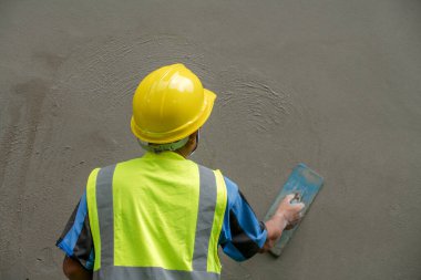 Plasterers are plastering walls in building construction with mortar and concrete.