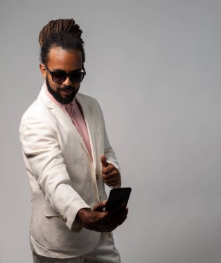 afro cuban with dreadlocks in suit taking a selfie