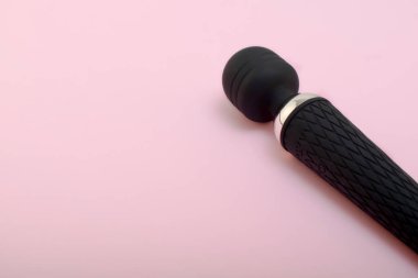 Adult sex toy, designer dildo vibrator isolated on pink background. Sex gadgets and devices for masturbation.A place for your text