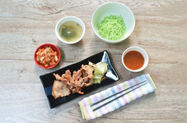  Kore usulü kızarmış domuz eti, lahana soslu ve susam yağı salatasında turşu.