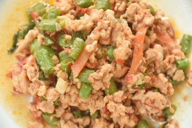  Baharatlı kızarmış tavuk, uzun fasulye ve tabakta fesleğen yaprağı.