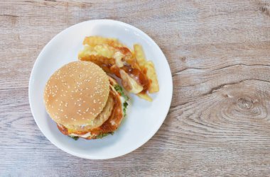  Kızarmış tavuk püresi hamburger patates kızartması soslu mayonez ve tabakta ketçap sosu.