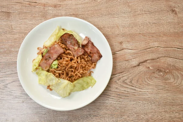  Kızarmış yakisoba Japon eriştesi dilimlenmiş domuz pastırması ve lahana.