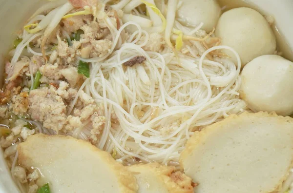 vermicelli rice noodles topping chop boiled pork and fish ball in soup on bowl