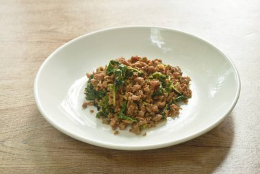 Baharatlı kızarmış domuz pirzolası ve biberli fesleğen yaprağı. 