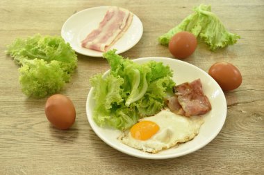 Yağda yumurta ve domuz pastırması ve taze marul.