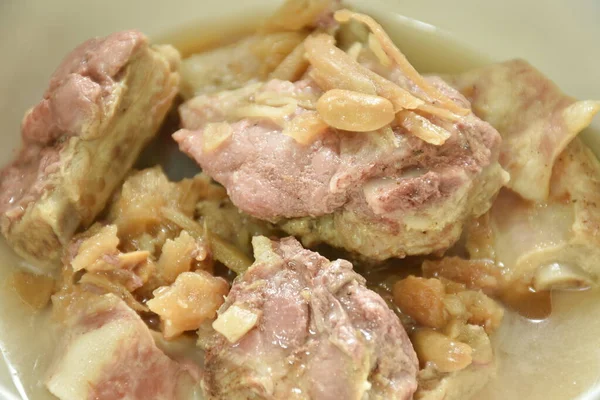 steamed pork bone topping slice ginger and ham in gravy sauce on bowl 