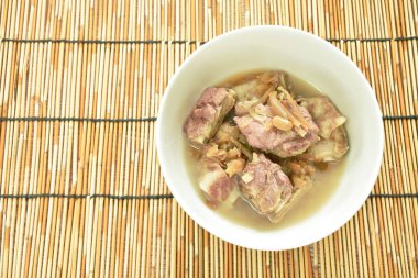 steamed pork bone topping slice ginger and ham in gravy sauce on bowl 