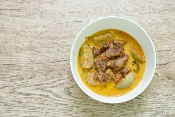 spicy boiled beef meat with eggplant in coconut milk green curry soup on bowl