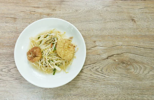 fried bean sprout with slice egg tofu and chop pork in plate on table