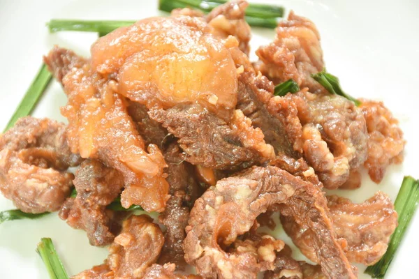 fried fermenting beef meat with pandan leaf on plate