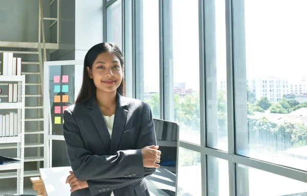 happy beautiful busimess Asian woman posing in glass window background with success moment at office