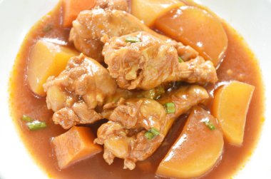 Haşlanmış tavuk budu, patates ve soslu sos tabağında güveç.